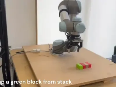 Robot arm picking up and stacking a green block